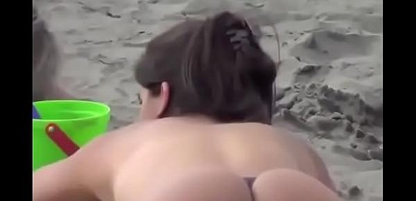  MILF tanning her firm, string bikini ass